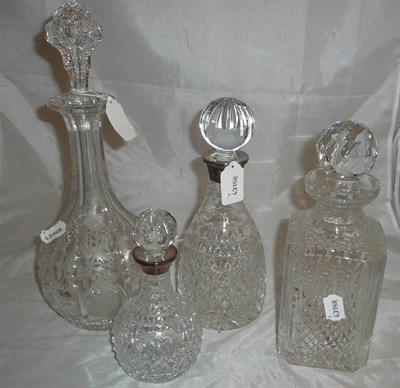 Lot 54 - Two cut glass decanters with stoppers and two decanters with silver rims and stoppers