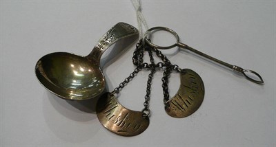 Lot 61 - Silver caddy spoon, two decanter labels and a pair of sugar tongs