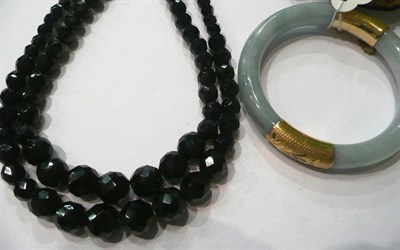 Lot 82 - A jade bangle and a French jet necklace