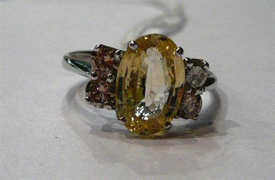 Lot 87 - A 14ct white gold yellow sapphire and diamond ring