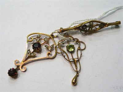 Lot 88 - A garnet and seed pearl pendant, a peridot pendant (a.f.), and an amethyst and seed pearl...