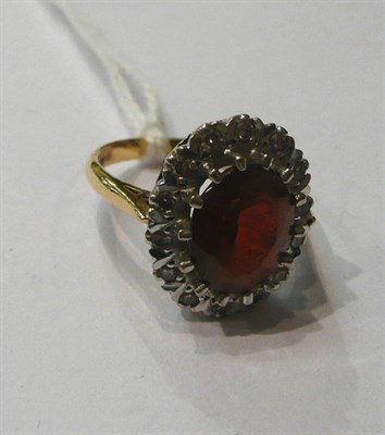 Lot 91 - A garnet and diamond cluster ring, stamped '18CT'