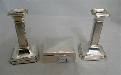 Lot 114 - A pair of loaded candlesticks and a cigarette box