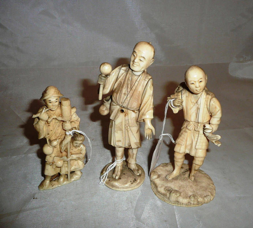 Lot 121 - Three Japanese ivory figures of farmers