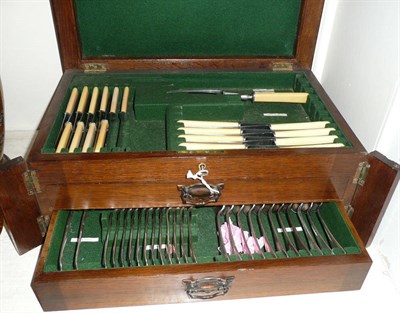 Lot 132 - An oak cased canteen of plated cutlery with lift up top and two drawers