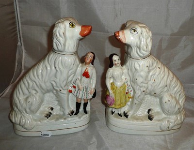 Lot 145 - Pair of Staffordshire dogs with children