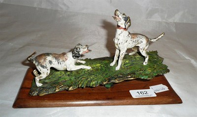 Lot 162 - Cold painted bronze olive wood mounted desk clip circa 1910 of foxhounds