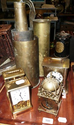 Lot 166 - Four modern mantel clocks, miners lamp, brass shell cases etc