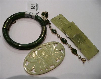 Lot 181 - A nephrite bangle with silver gilt mounts, a chain linked bracelet, and three carved panels of jade