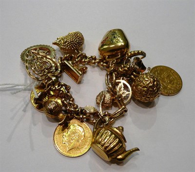 Lot 182 - Curb bracelet hung with assorted charms including two soldered half sovereigns and an American five