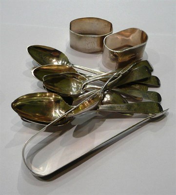 Lot 190 - Twelve silver teaspoons, two napkin rings, a pair of bright cut tongs, 7oz