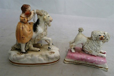 Lot 303 - Staffordshire porcelain group 'Child and Goat' and another of a poodle (2)