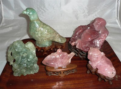 Lot 332 - A large carved rose quartz figure of a budha, another of a shishi, a fish, a bird and a man