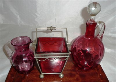 Lot 338 - A cranberry glass ewer, a base metal sugar basket with cranberry glass liner with etched...