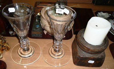 Lot 339 - Pair of William Yeoward oversized glasses/vases and a carved treen candlestick (3)