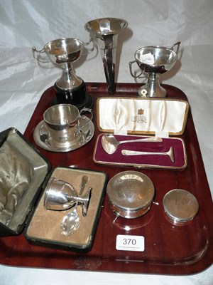 Lot 370 - A silver cup and saucer, two silver twin handled cups on stand, silver loaded spill vase, cased egg