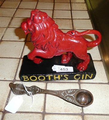 Lot 453 - Booth Gin standing lion advertising item and a pierced copper spoon (2)