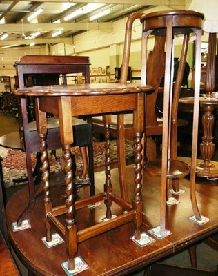 Lot 536 - A mahogany torchere and an oak window table