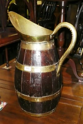 Lot 543 - Large oak jug with brass bindings and handle