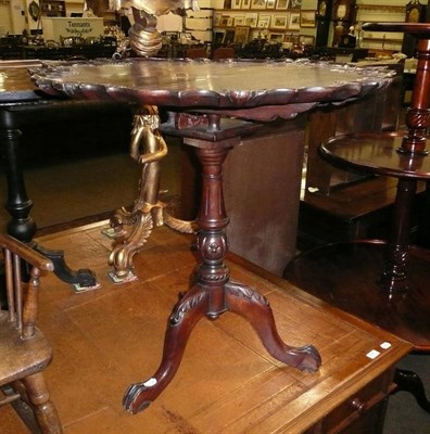 Lot 556 - Scalloped edge tripod table on later base