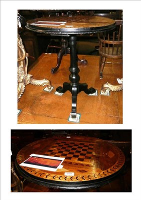 Lot 559 - A Victorian inlaid walnut games table