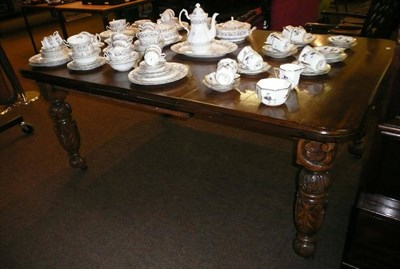 Lot 574 - Carved oak extending dining table with one leaf and winder