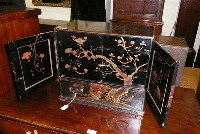 Lot 579 - A Japanese lacquer table cabinet