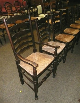 Lot 590 - Set of eight rush seated ladder back chairs including two carvers