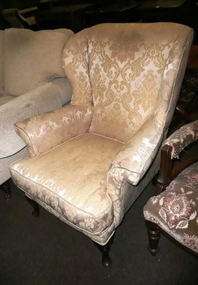 Lot 604 - Wing armchair upholstered in cream damask