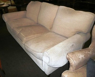 Lot 605 - A cream chenille covered three seater settee