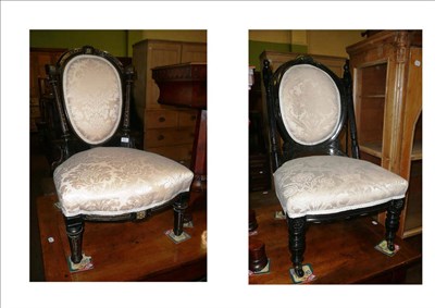 Lot 610 - Two late 19th century ebonised nursing chairs