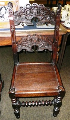 Lot 660 - A carved oak chair with bobbin turned stretchers