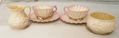Lot 12 - A pair of Belleek Neptune cups and saucers (second black mark) (a.f.) and a Belleek cream jug...