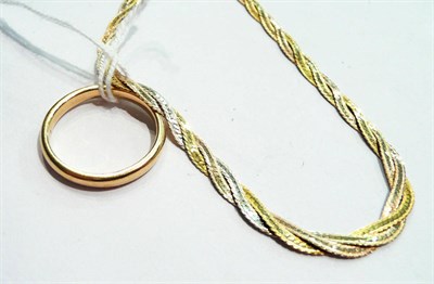 Lot 63 - An 18ct gold band ring (hallmark very worn) and a three colour necklace stamped '750'