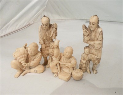 Lot 123 - Four Japanese ivory okimonos - a man making a hobby horse, man with conch shell, boys with toys and