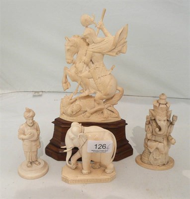 Lot 126 - An Indian ivory carving of St George and the Dragon, an Indian ivory figure of a man with...