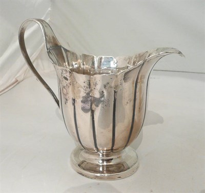 Lot 129 - A George III silver fluted jug. London 1799, 7oz