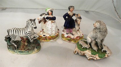 Lot 158 - A pair of Staffordshire figural pen holders, a zebra, a poodle and pups (a.f.)