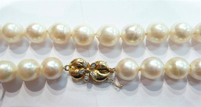 Lot 210 - Cultured pearl necklace with diamond set clasp stamped 18k