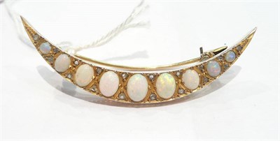 Lot 225 - An opal set crescent brooch