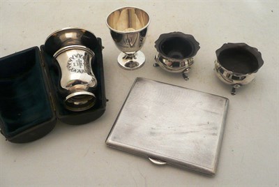 Lot 250 - A silver cigarette case, a pair of silver salts, a silver egg cup and a cased travelling...