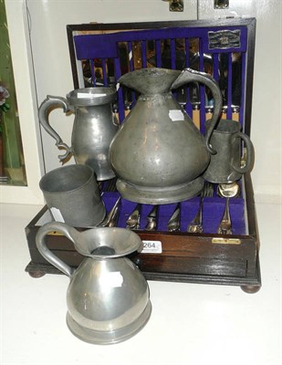 Lot 264 - An oak canteen of plated flatware, two pewter conical measures, two other measures and a cup