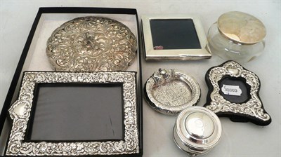 Lot 280 - Three silver photograph frames, a circular hand mirror, an ashtray, a silver trinket box and a...