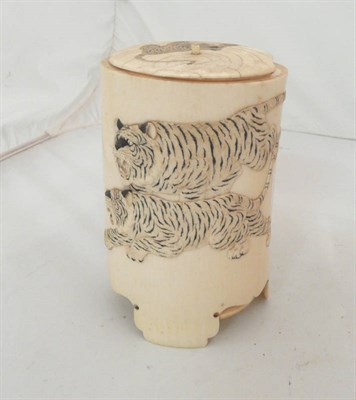 Lot 290 - A Meiji period ivory vase and cover decorated in relief with two tigers hunting a lion (lid a.f.)