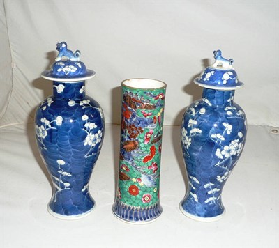 Lot 339 - Pair of Chinese blue and white vases and covers and a Chinese sleeve vase with clobbered decoration