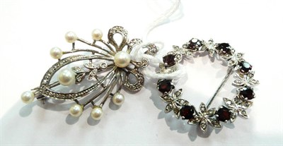 Lot 366 - Two 9ct white gold brooches, one set with garnets and marcasite the other with cultured pearls...