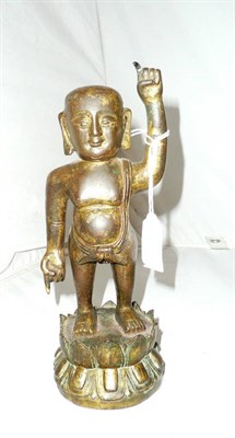 Lot 389 - A small gilt bronze figure of a Buddhistic young boy, probably late Ming/early Qing