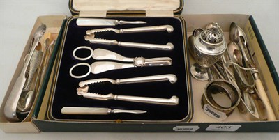 Lot 403 - Four various silver sugar tongs, seven silver teaspoons, two silver napkin rings, a butter...