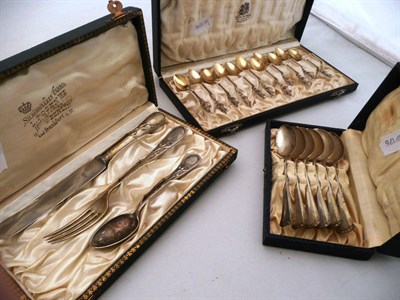 Lot 432 - An Art Nouveau white metal christening set stamped 800, 11 cased coffee spoons & 6 teaspoons