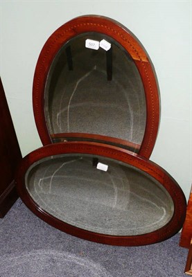 Lot 507 - A pair of Edwardian mahogany framed oval wall mirrors